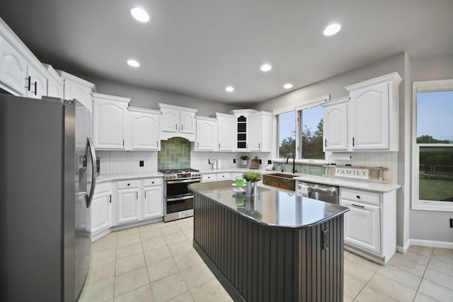 874 Pinecrest, Dexter, MI 48130 - kitchen featuring appliances with stainless steel finishes, decorative backsplash, white cabinetry, recessed lighting, and light tile patterned flooring