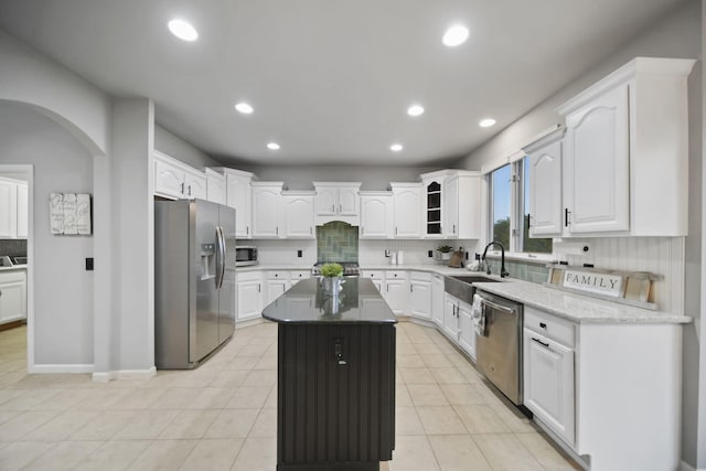 874 Pinecrest, Dexter, MI 48130 - kitchen featuring stainless steel appliances, arched walkways, decorative backsplash, white cabinetry, and recessed lighting