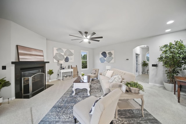 874 Pinecrest, Dexter, MI 48130 - carpeted living room with arched walkways, a glass covered fireplace, a ceiling fan, and recessed lighting