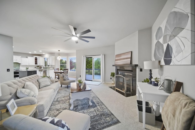 874 Pinecrest, Dexter, MI 48130 - living room featuring ceiling fan, light carpet, a fireplace with flush hearth, and recessed lighting