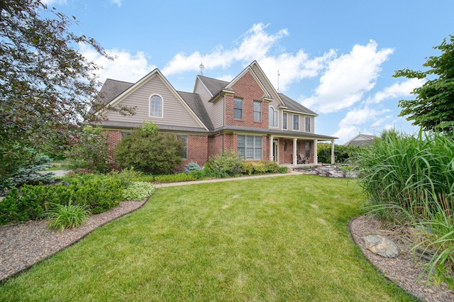 874 Pinecrest, Dexter, MI 48130 - view of front facade featuring brick siding and a front yard