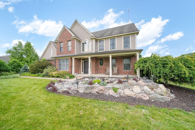 874 Pinecrest, Dexter, MI 48130 - view of front of property with brick siding, a front lawn, and covered porch