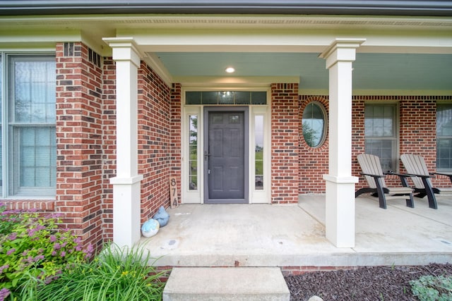 874 Pinecrest, Dexter, MI 48130 - property entrance featuring covered porch and brick siding
