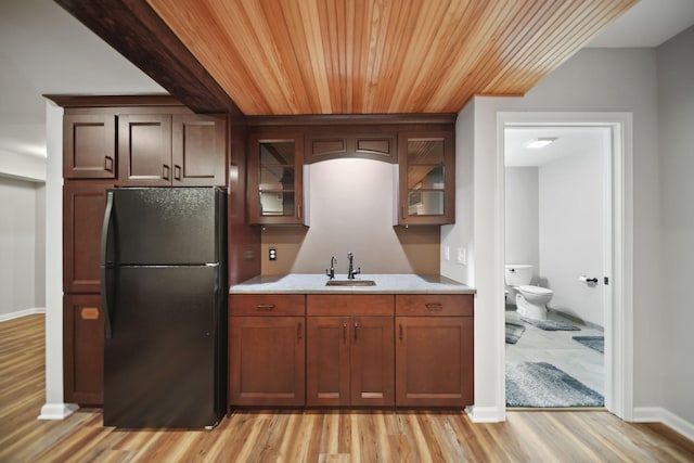 874 Pinecrest, Dexter, MI 48130 - kitchen featuring freestanding refrigerator, light countertops, light wood-style flooring, glass insert cabinets, and wood ceiling