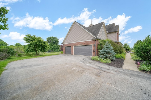 874 Pinecrest, Dexter, MI 48130 - view of home's exterior featuring brick siding, driveway, and a garage