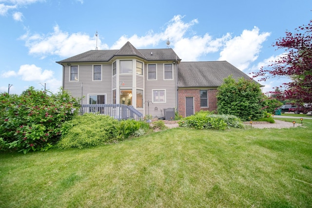 874 Pinecrest, Dexter, MI 48130 - back of property with a lawn and a wooden deck