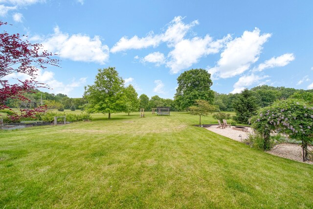 874 Pinecrest, Dexter, MI 48130 - view of green lawn featuring an outdoor fire pit