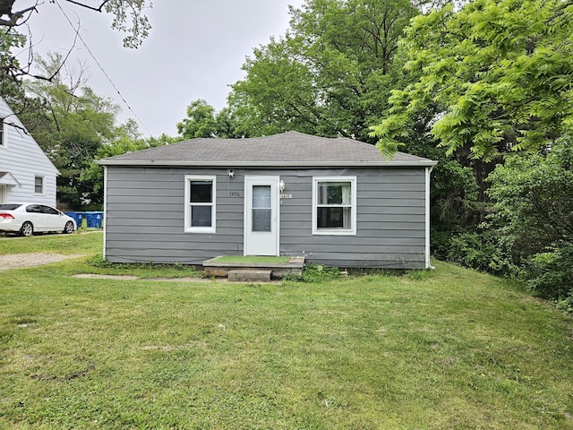 1406 Bixby Rd, Kalamazoo, MI 49048 - view of front of property featuring a front lawn and a shingled roof