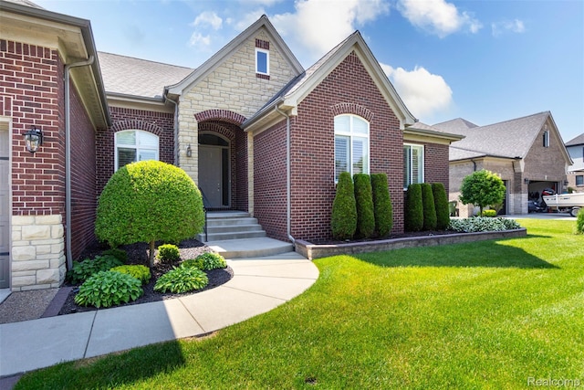 48913 Pinebrook Dr, Utica, MI 48315 - view of front of property featuring a front yard, brick siding, and stone siding