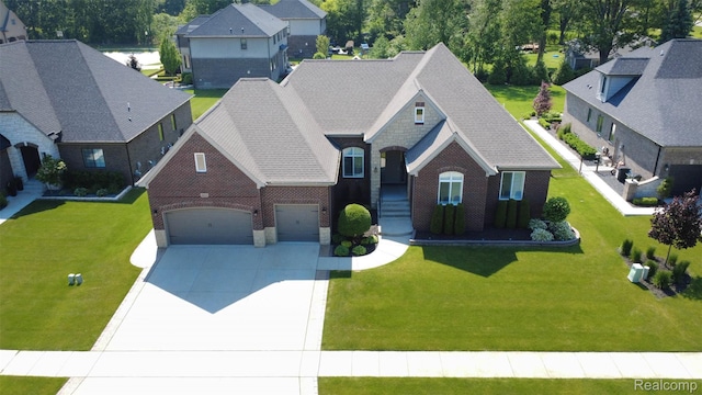 48913 Pinebrook Dr, Utica, MI 48315 - view of front facade with driveway, brick siding, an attached garage, and a front lawn