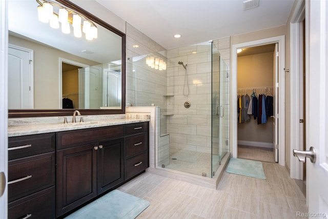 48913 Pinebrook Dr, Utica, MI 48315 - bathroom featuring a spacious closet, vanity, a stall shower, and recessed lighting