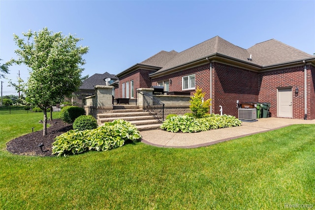 48913 Pinebrook Dr, Utica, MI 48315 - view of front of house featuring brick siding, a front lawn, and a shingled roof