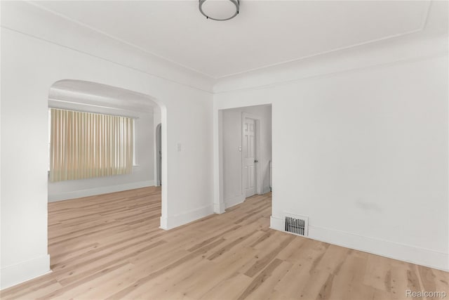 12719 Sussex St, Detroit, MI 48227 - empty room featuring arched walkways and wood finished floors