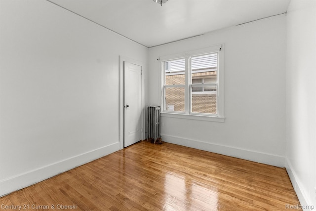 5527 Chalmers St, Detroit, MI 48213 - unfurnished room with radiator and wood finished floors