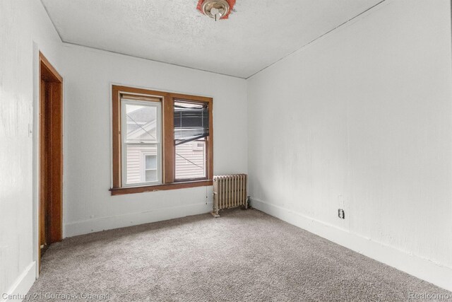 5527 Chalmers St, Detroit, MI 48213 - carpeted empty room featuring radiator and baseboards
