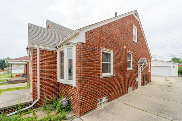 15648 Stricker Ave, Sterling Heights, MI 48021 - view of property exterior featuring brick siding, a shingled roof, an outdoor structure, and a garage