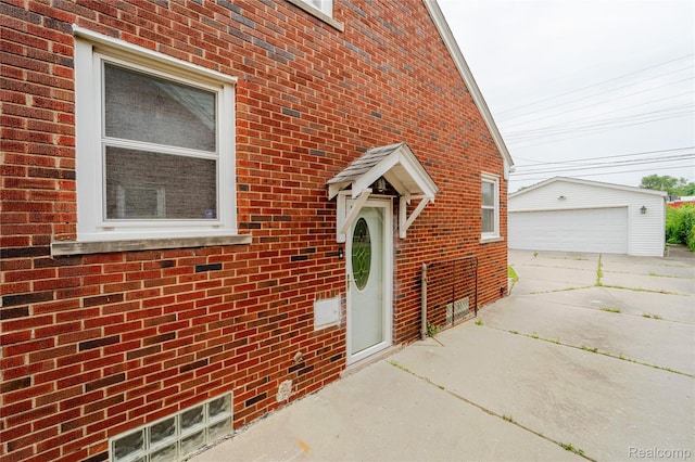 15648 Stricker Ave, Sterling Heights, MI 48021 - view of exterior entry with a garage and brick siding