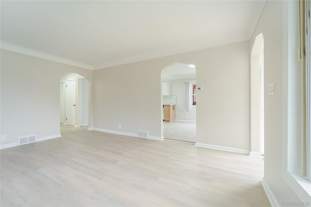 15648 Stricker Ave, Sterling Heights, MI 48021 - empty room with arched walkways and light wood-type flooring