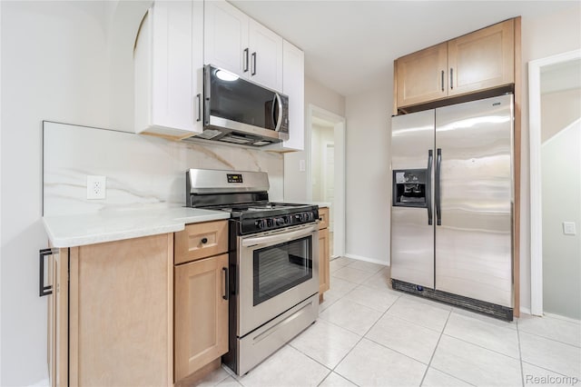 15648 Stricker Ave, Sterling Heights, MI 48021 - kitchen featuring stainless steel appliances, light countertops, light tile patterned flooring, and light brown cabinetry