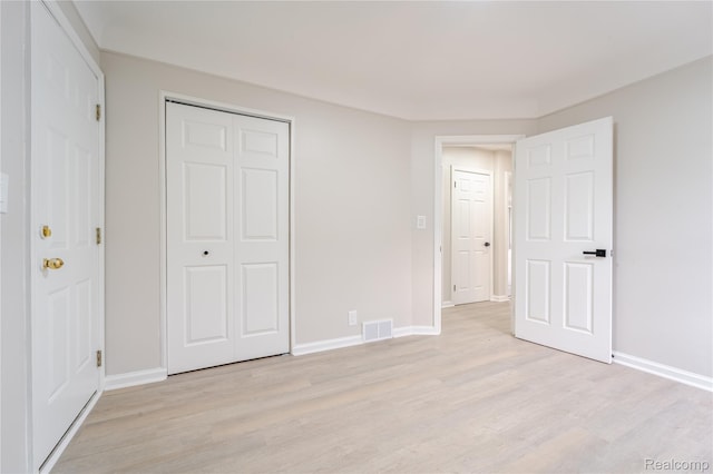 15648 Stricker Ave, Sterling Heights, MI 48021 - unfurnished bedroom featuring light wood-style floors and a closet