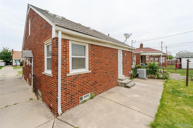 15648 Stricker Ave, Sterling Heights, MI 48021 - view of home's exterior with brick siding, a patio, and entry steps