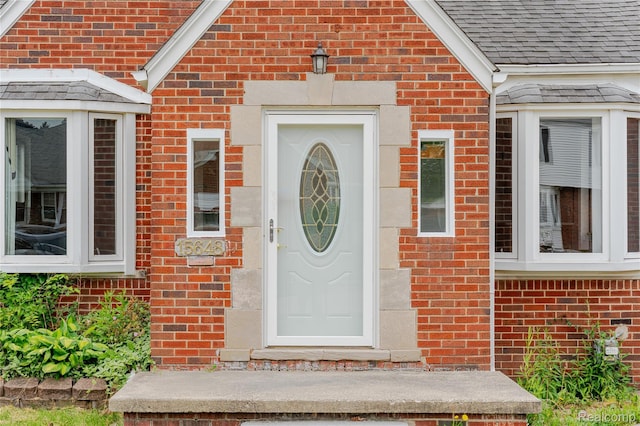 15648 Stricker Ave, Sterling Heights, MI 48021 - view of exterior entry featuring brick siding and a shingled roof