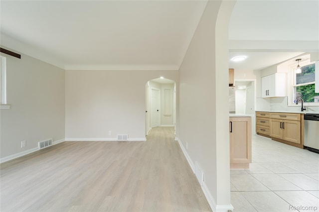 15648 Stricker Ave, Sterling Heights, MI 48021 - unfurnished living room featuring arched walkways and light wood-style floors