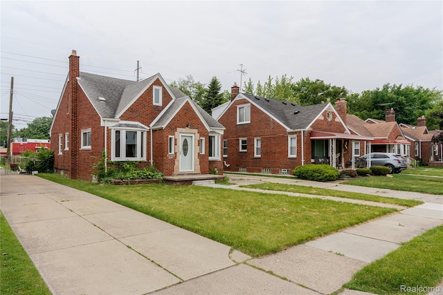 15648 Stricker Ave, Sterling Heights, MI 48021 - bungalow-style house featuring brick siding, a front lawn, and a chimney
