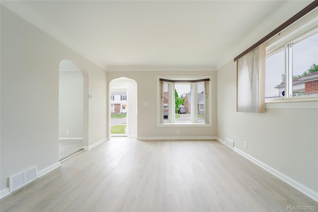 15648 Stricker Ave, Sterling Heights, MI 48021 - unfurnished living room with light wood-style flooring and arched walkways