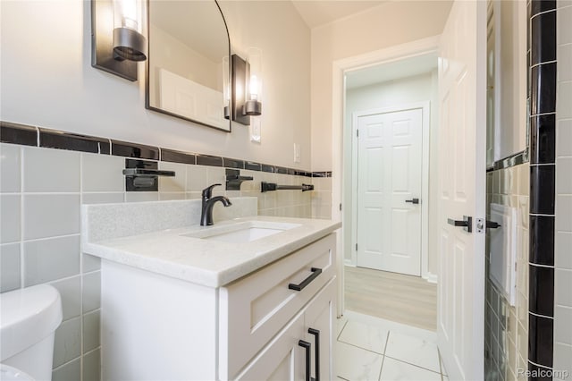 15648 Stricker Ave, Sterling Heights, MI 48021 - bathroom featuring vanity, tile walls, and marble finish floors