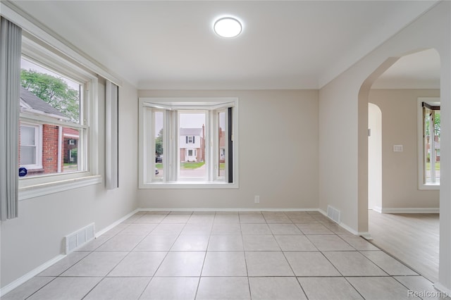 15648 Stricker Ave, Sterling Heights, MI 48021 - spare room featuring plenty of natural light, arched walkways, and light tile patterned flooring