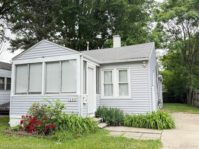 1149 E Milton Ave, Hazel Park, MI 48030 - bungalow-style home with a chimney, roof with shingles, and entry steps