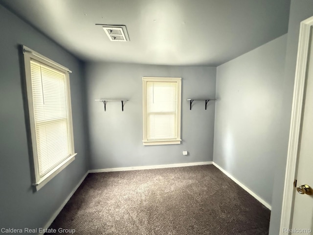 1149 E Milton Ave, Hazel Park, MI 48030 - unfurnished room with dark colored carpet and healthy amount of natural light