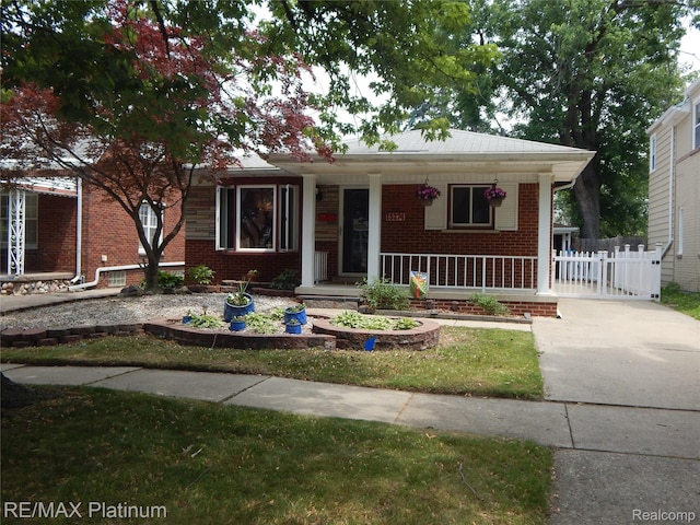 15274 Regina Ave, Allen Park, MI 48101 - view of front of property with brick siding, a porch, and concrete driveway