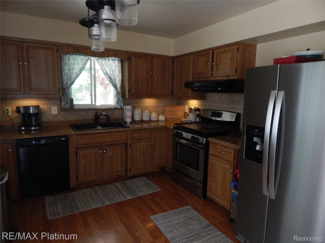 15274 Regina Ave, Allen Park, MI 48101 - kitchen with stainless steel appliances, exhaust hood, decorative backsplash, and brown cabinets