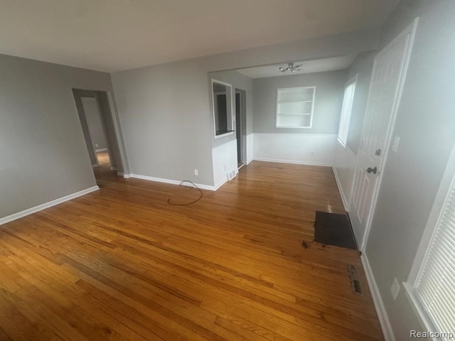 248 W Longfellow Ave, Pontiac, MI 48340 - unfurnished room with wood finished floors and built in shelves