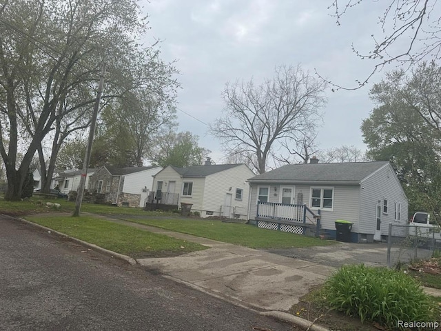 248 W Longfellow Ave, Pontiac, MI 48340 - view of front of home with a front lawn, a wooden deck, a chimney, and a residential view