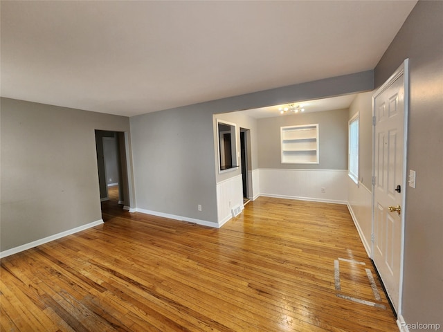 248 W Longfellow Ave, Pontiac, MI 48340 - spare room featuring light wood finished floors and a chandelier