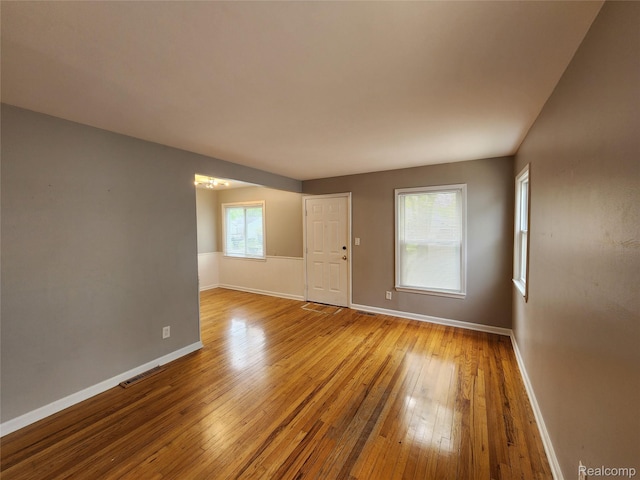 248 W Longfellow Ave, Pontiac, MI 48340 - empty room featuring hardwood / wood-style flooring and a chandelier