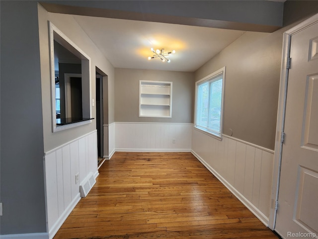 248 W Longfellow Ave, Pontiac, MI 48340 - spare room featuring wainscoting, hardwood / wood-style flooring, and built in shelves