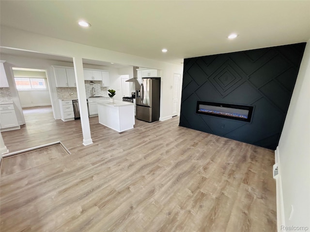 26046 Eureka Dr, Warren, MI 48091 - unfurnished living room featuring a fireplace, light wood finished floors, and recessed lighting