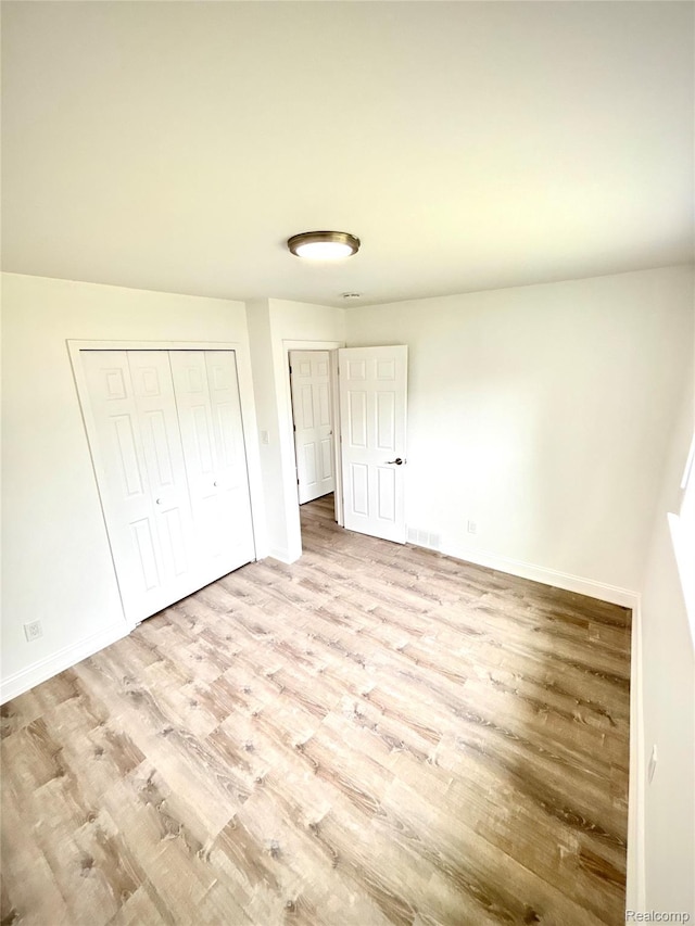 26046 Eureka Dr, Warren, MI 48091 - unfurnished bedroom featuring wood finished floors and a closet