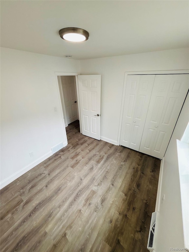 26046 Eureka Dr, Warren, MI 48091 - unfurnished bedroom featuring wood finished floors and a closet