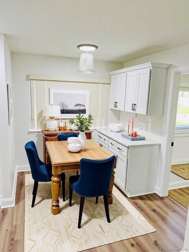 26046 Eureka Dr, Warren, MI 48091 - dining area with light wood-type flooring and baseboards