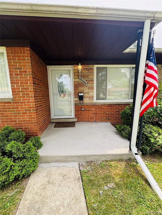 26046 Eureka Dr, Warren, MI 48091 - property entrance with brick siding and covered porch