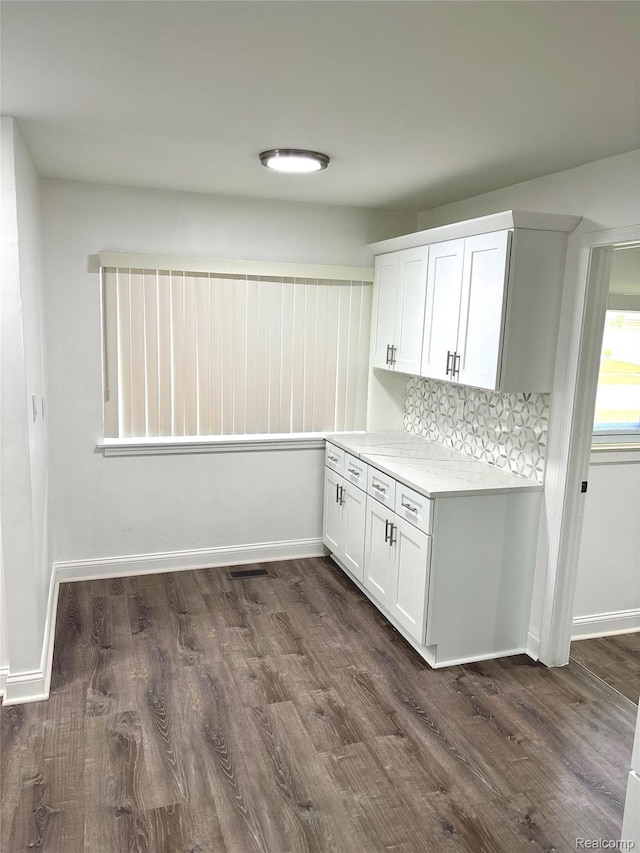 26046 Eureka Dr, Warren, MI 48091 - kitchen featuring dark wood-style flooring, white cabinetry, and backsplash
