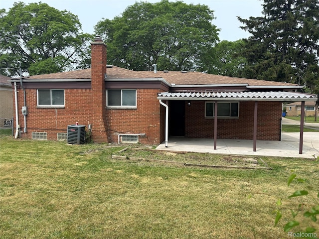 26046 Eureka Dr, Warren, MI 48091 - rear view of house featuring a patio area, a lawn, a chimney, and brick siding