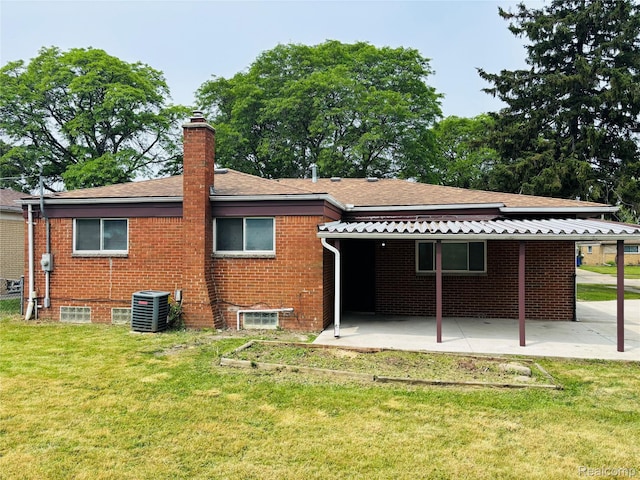 26046 Eureka Dr, Warren, MI 48091 - back of house featuring a lawn, a patio, a chimney, and brick siding