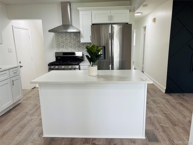 26046 Eureka Dr, Warren, MI 48091 - kitchen with wall chimney exhaust hood, appliances with stainless steel finishes, white cabinetry, and light countertops