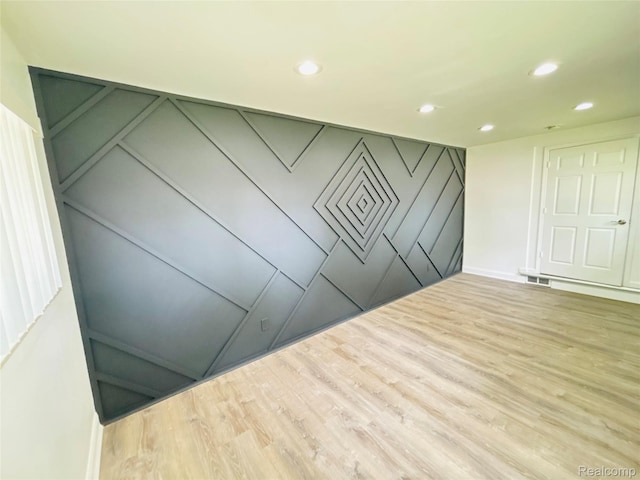 26046 Eureka Dr, Warren, MI 48091 - unfurnished room featuring recessed lighting, wood finished floors, and a decorative wall